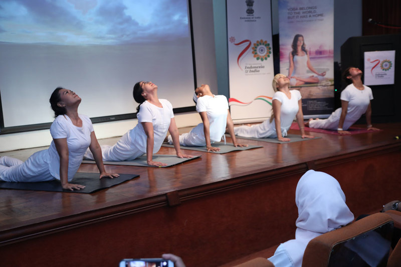 Participants of the International Day of Yoga celebration practicing yoga together.