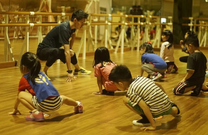 Children involved in fun and healthy activity at Rockstar Gym with professional instructor.